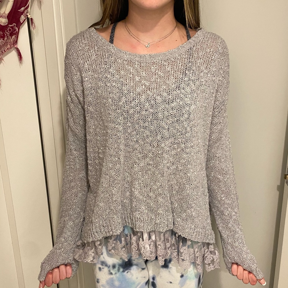 Grey sweater with laced bottom.